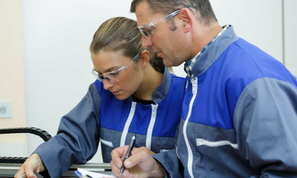 man and woman in factory doing risk assessment