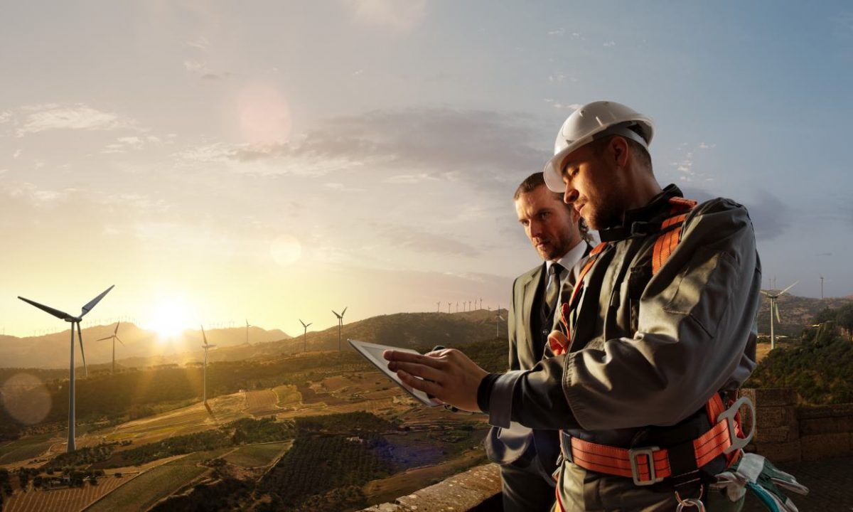 Windmill engineer and businessman planing new ecology project. t