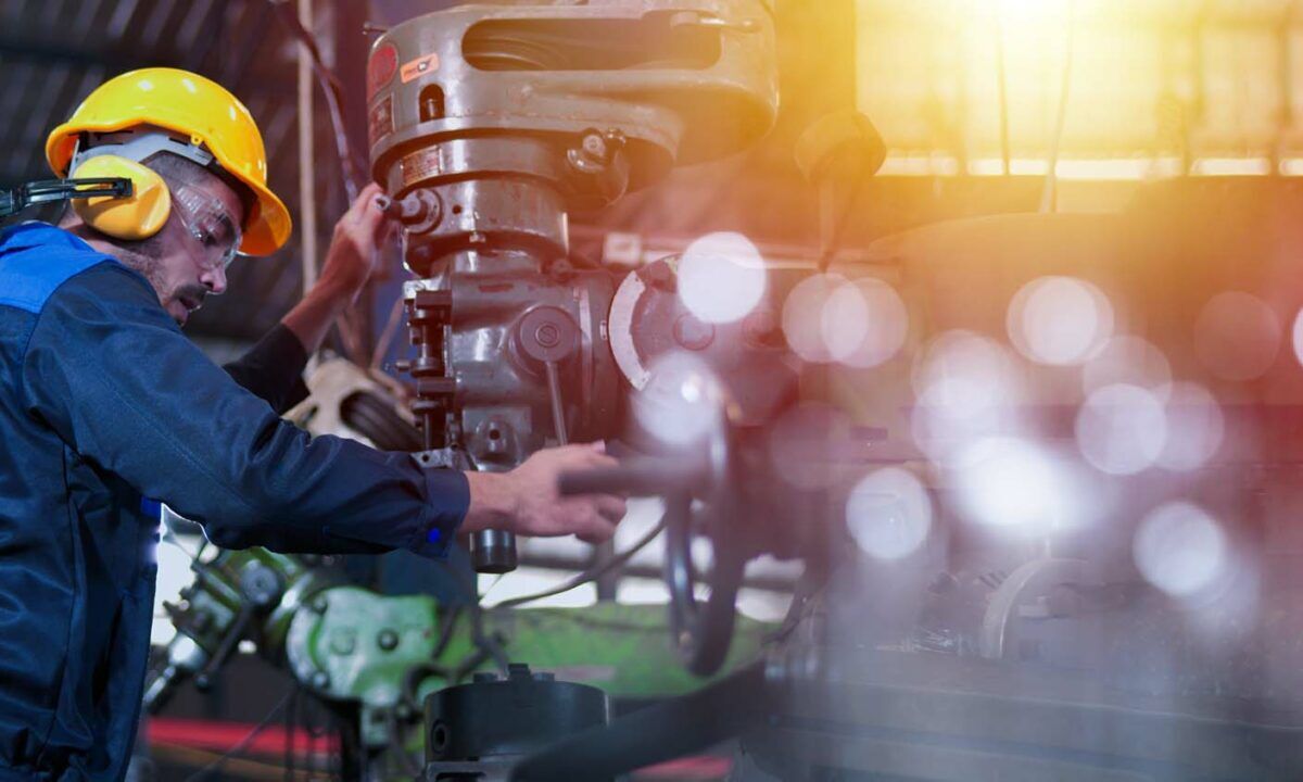 Professional industrial engineer, technician, factory worker wear hard hat, safety glasses. While checking, set up, control machine heavy industry factory. Employee working in manufacturing facility.