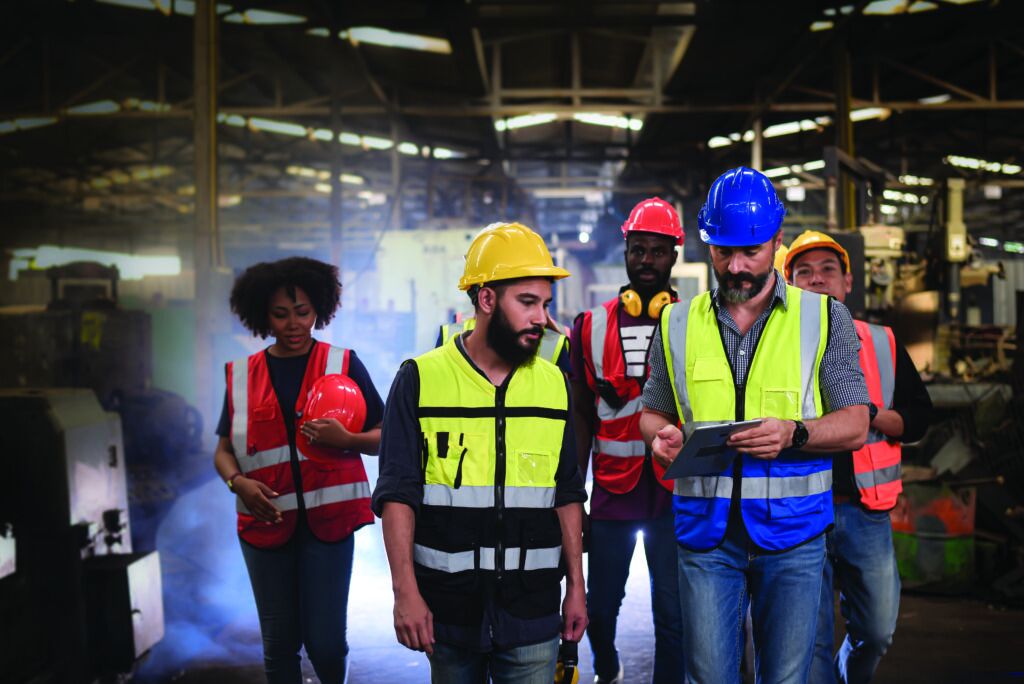 Colleagues analyzing safety performance data reflecting how U.S. companies use integrated platforms for real-time safety training. 