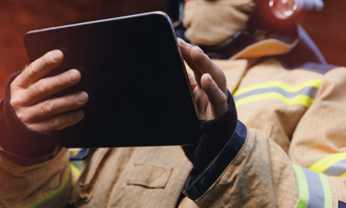 Emergency responder entering safety incident data into a digital reporting system.
