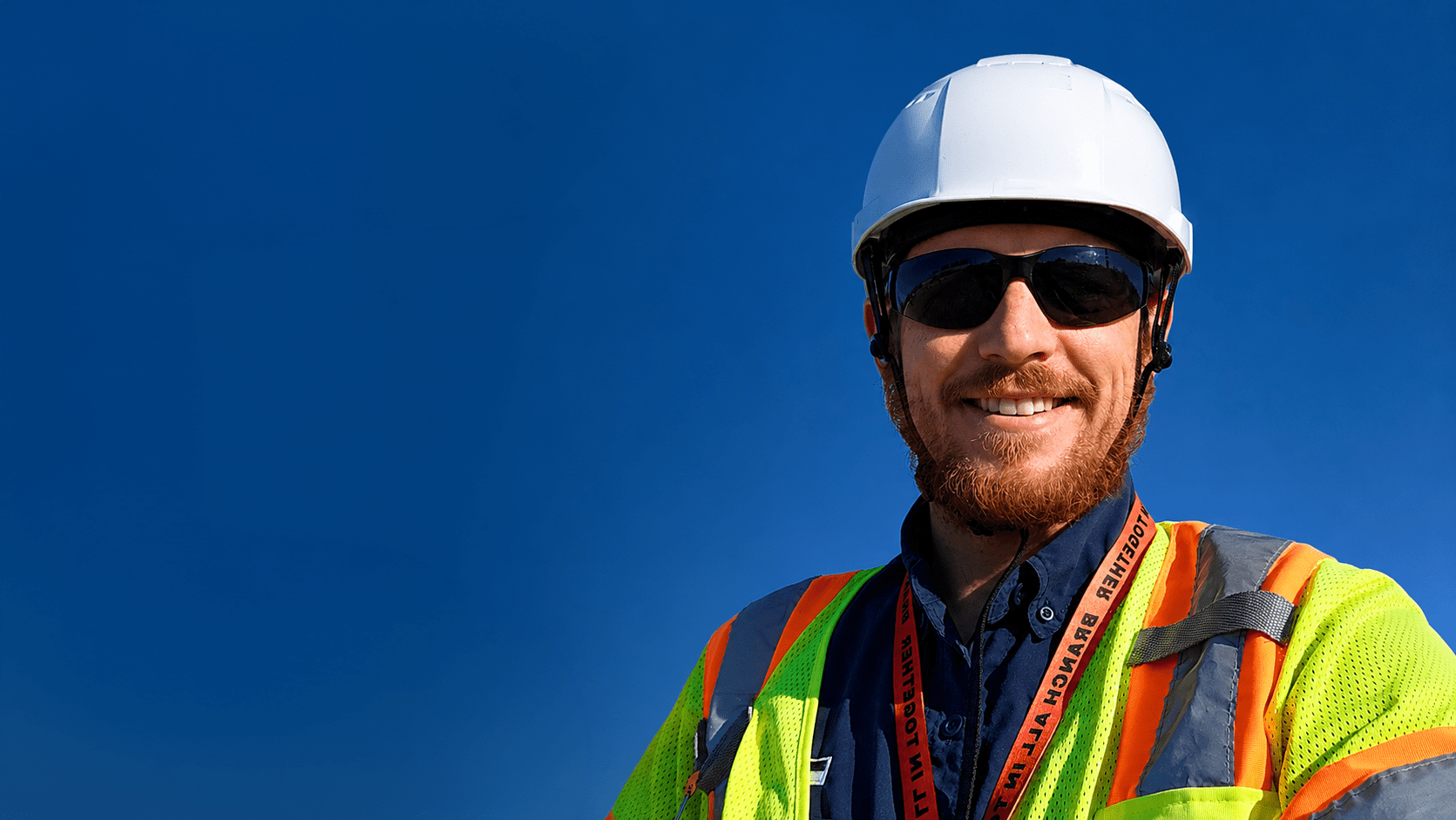 Construction safety manager speaking with workers about building a stronger job site safety culture.