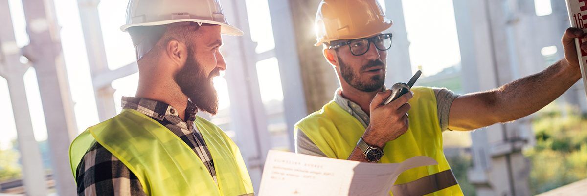 two workers checking grade