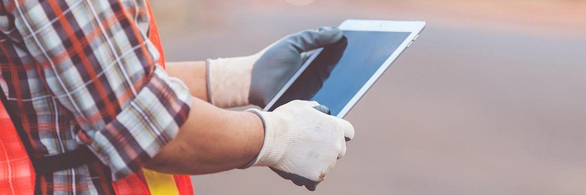 spanish worker using a tablet while working or taking spanish safety training