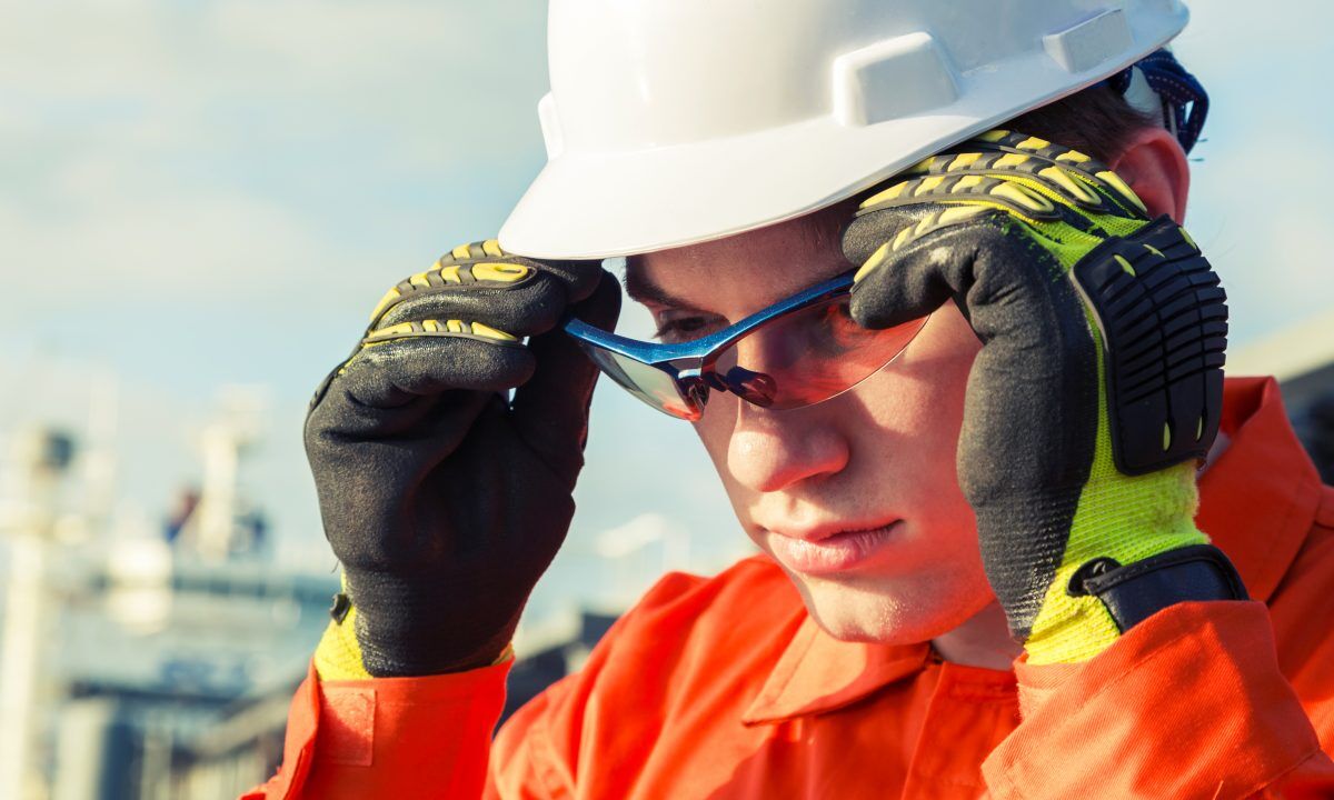 Orange robe engineer is wearing the safety goggles.