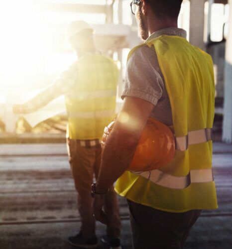 Portrait of construction engineers working on building site together