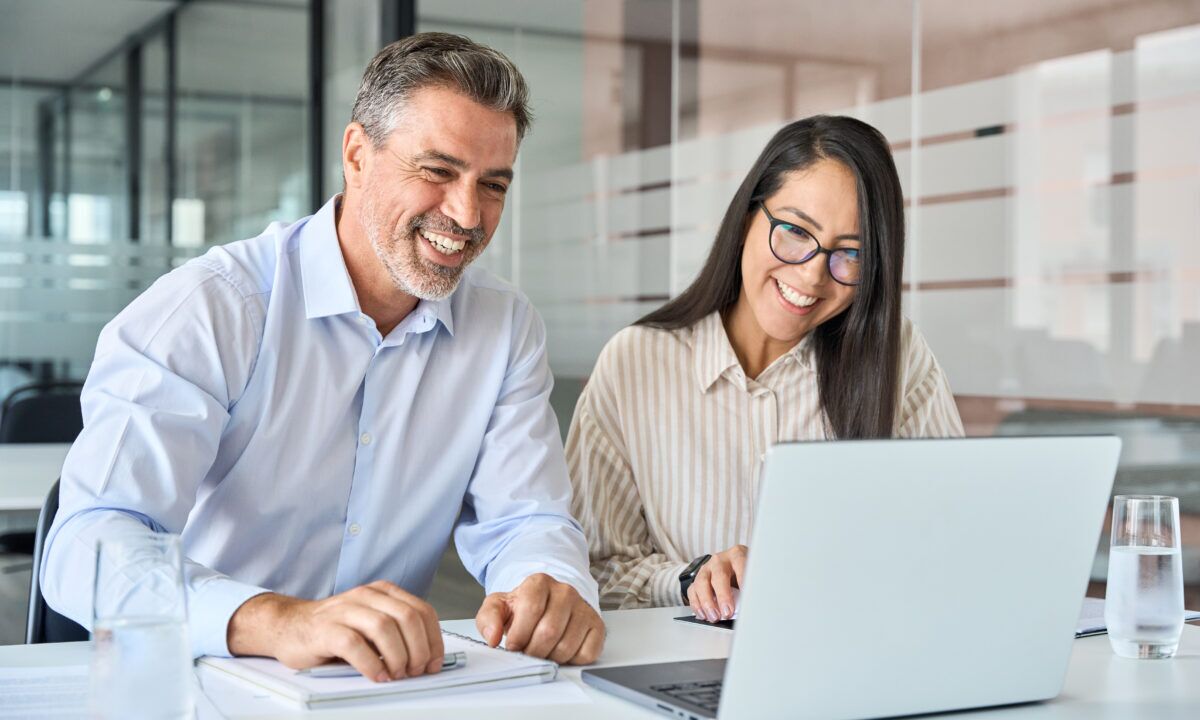 Happy diverse executives team two professional managers looking at Learning management software