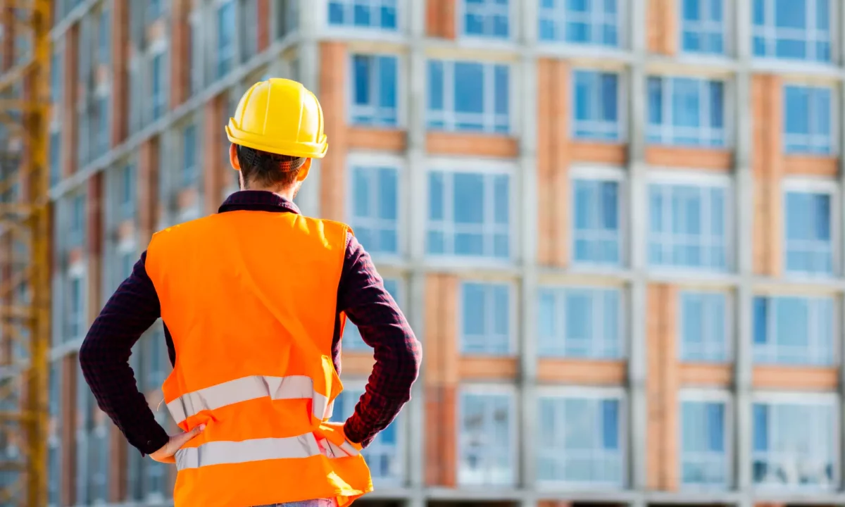 A Construction Worker standing in front of a site.