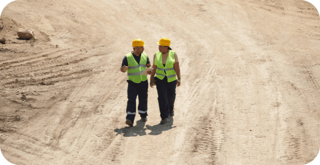 Two construction workers reviewing a construction site.