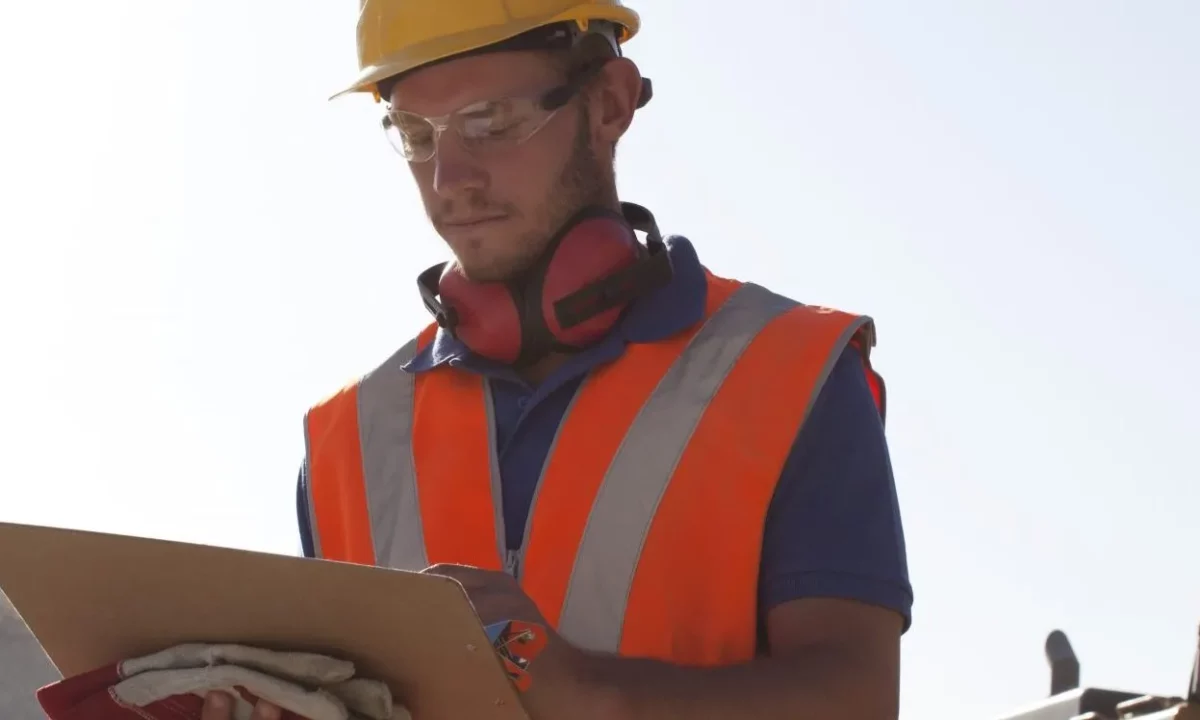 Warehouse worker uses tablet to access LMS for safety training