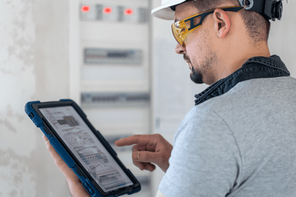 Engineer using tablet for site inspection-min Construction Safety Inspection Software: Ensure Compliance & Site Safety