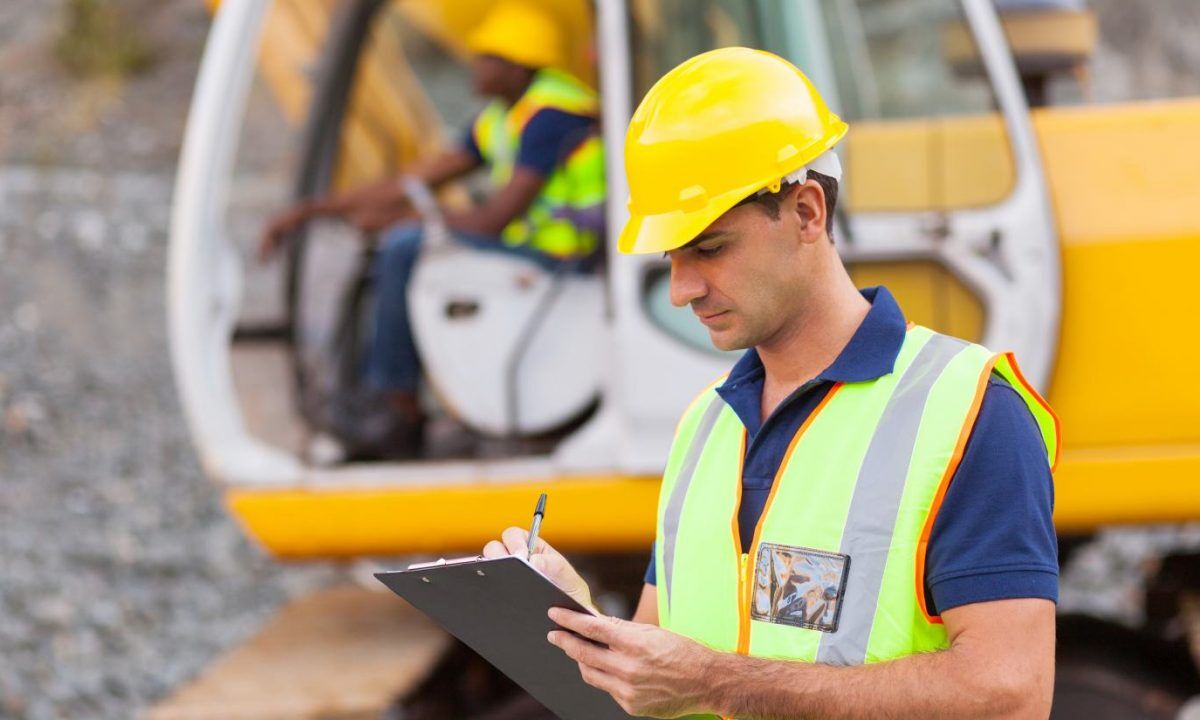 construction manager writing report at construction site