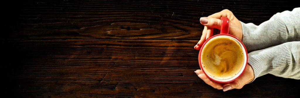 A warm cappuccino on a beautiful wood table. 