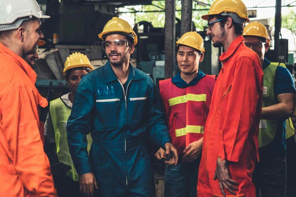 Skillful worker attending brief meeting in the factory about qr codes.