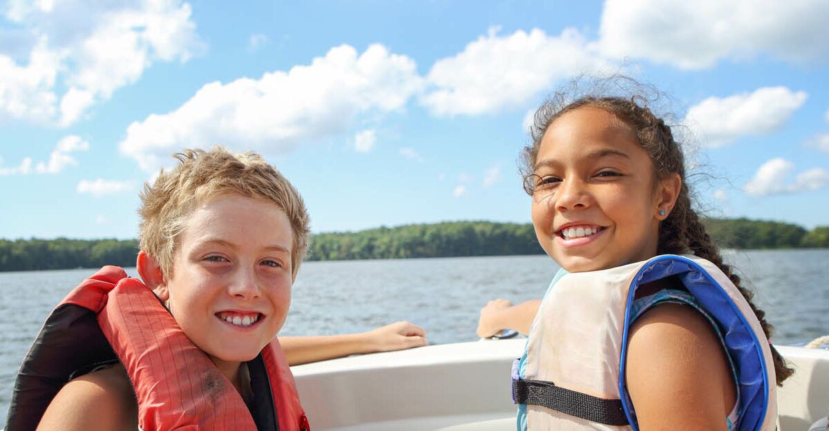 children safety enjoying boating on a lake