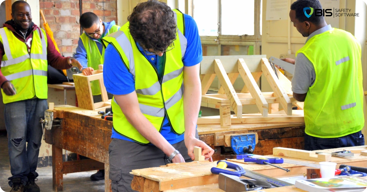 Workers in safety vests at carpentry table