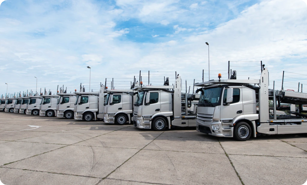 A fleet of Driverless Trucks parked in a Truck stop.