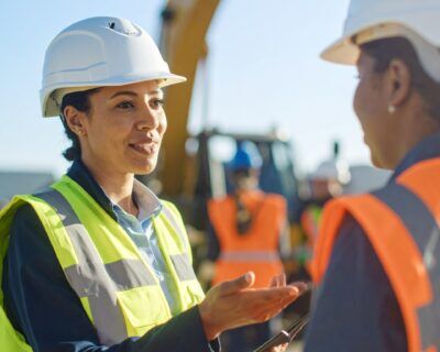 Safety leader engaging a team member in a discussion about workplace culture on-site.