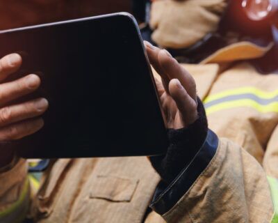 Emergency responder entering safety incident data into a digital reporting system.