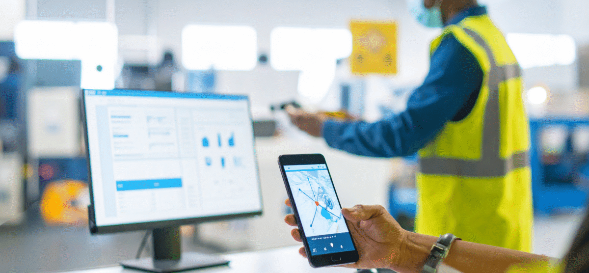 Safety team member captures hazard details on a smartphone, reinforcing real-time hazard reporting on site.