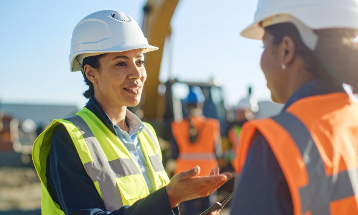 Safety leader engaging a team member in a discussion about workplace culture on-site.